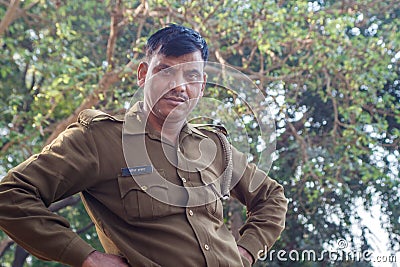 AGRA, INDIA - DECEMBER 2012: Indian police officer looking at camera on a river bank Editorial Stock Photo