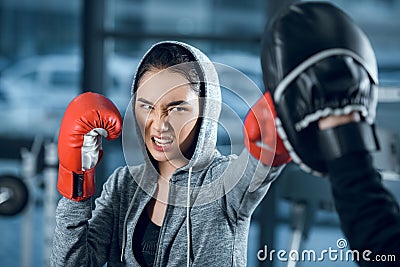 agressive young female boxer training Stock Photo