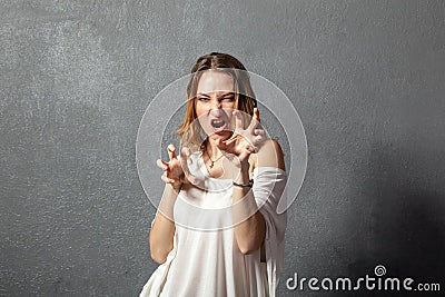Agressive young woman posing with hands Stock Photo