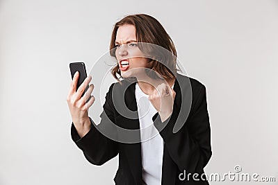 Agressive young woman standing talking by phone Stock Photo