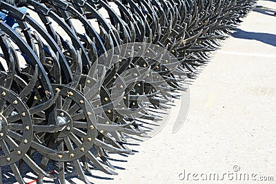 Agricultural combination tractor-soil cultivator for field work. Mounted field cultivator close up Stock Photo