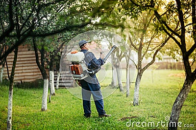 Agricultural details - farmer spraying pesticides and substances for local plant treatments Stock Photo