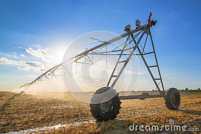 Agricultural irrigation on harvested wheat stubble field Stock Photo