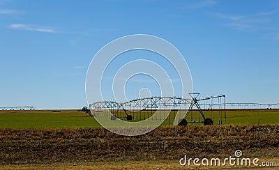 Agricultural irrigation system watering field on sunny day Stock Photo