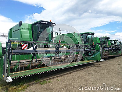 agricultural machinery in an open parking lot. combines with reapers and mowers Editorial Stock Photo