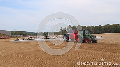 Agricultural machinery - tractors, seeders, sprayers and cultivators work in the field Editorial Stock Photo