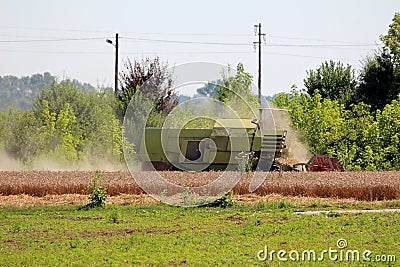 Agricultural old vintage combine harvester with hydrostatic drive and large capacity tank working in local field Stock Photo