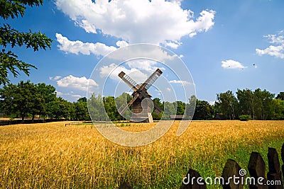 Agricultural summer landscape with old windmill Stock Photo