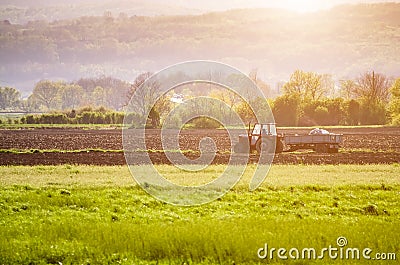 Agricultural tractor working on a field Stock Photo