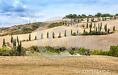 Agriculture plowing tractor with a cultivator plow the field after the harvest. Stock Photo