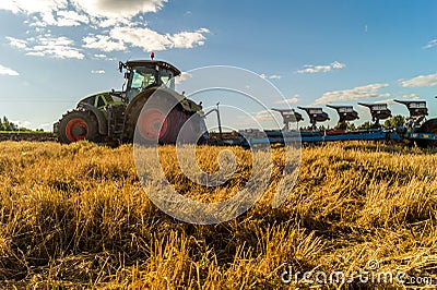 Agriculture plowing tractor on wheat cereal fields Stock Photo