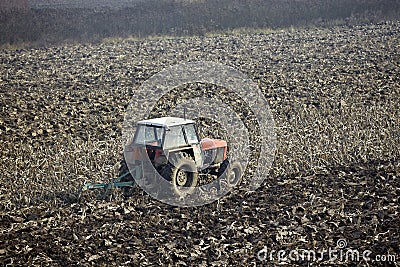 Agriculture tractor cultivated land Stock Photo
