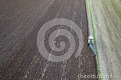 Tractor working in the field. Aerial view. Stock Photo