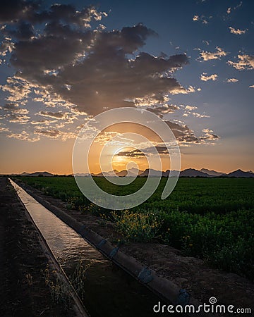 Agriculture water canal next to farmland in Tucson, Arizona. Stock Photo