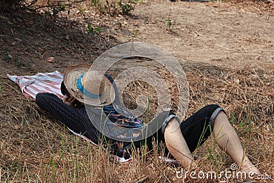 Agriculturist male use the loincloth on the floor for relax sleeping with hat close the face on nature Stock Photo