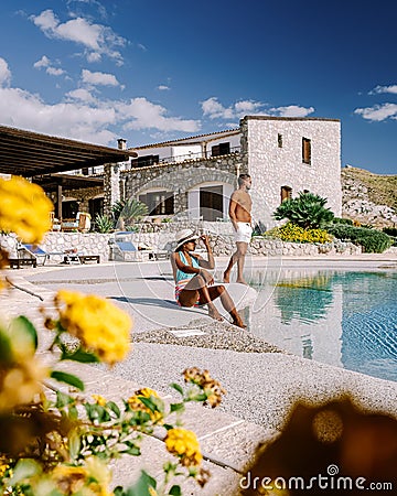 a couple on vacation at Sicilian Agriturismo relaxing by the pool, bed and breakfast Sicily Italy Stock Photo