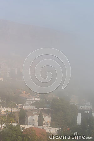 AGUADULCE, SPAIN - 12 DECEMBER 2023 Panorama of dense fog that covered many buildings and the sea landscape in a small seaside Editorial Stock Photo