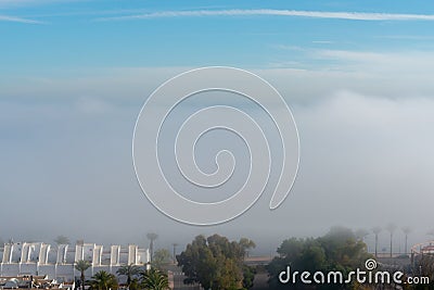 AGUADULCE, SPAIN - 12 DECEMBER 2023 Panorama of dense fog that covered many buildings and the sea landscape in a small seaside Editorial Stock Photo