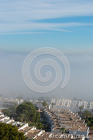 AGUADULCE, SPAIN - 12 DECEMBER 2023 Panorama of dense fog that covered many buildings and the sea landscape in a small seaside Editorial Stock Photo