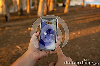 Aguadulce, Spain; October 2nd 2021: Woman`s hands using her mobile phone. Consulting Radar COVID app Editorial Stock Photo