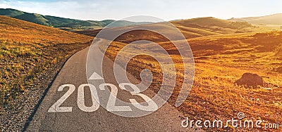 2023 ahead, new year number on winding road through beautiful countryside landscape Stock Photo