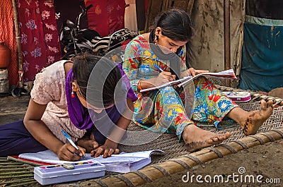 Unidentified school girls of Indian Ethnicity busy doing homework Editorial Stock Photo