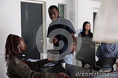 Ai cloud programers talking about html script in looking at code on computer Stock Photo
