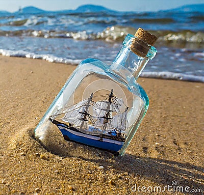 AI generated image of a miniature ship in bottle in a sandy beach Stock Photo