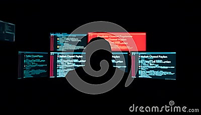 silhouette of a hacker in a dark room full of computers hacking Stock Photo