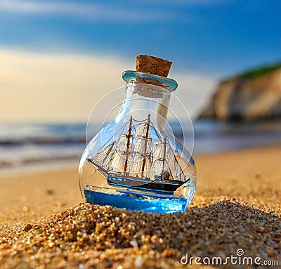 AI generated realistic souvenir consisting of a medieval era ship in a bottle in a sandy beach Stock Photo