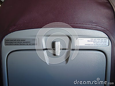 Aicraft seat with multilingual tags Editorial Stock Photo