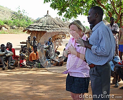 Aid relief volunteer emotional crying in face of poverty village Africa Editorial Stock Photo