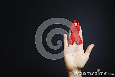 Aids ribbon on hands, hiv Stock Photo