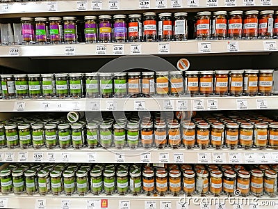 ainsbury`s supermarket shelves with a huge selection of culinary herbs and spices Editorial Stock Photo