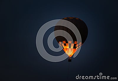 Air balloon with bright burning flame flying in the night Stock Photo