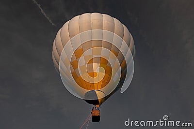 Air balloon with bright burning flame flying in the night Stock Photo