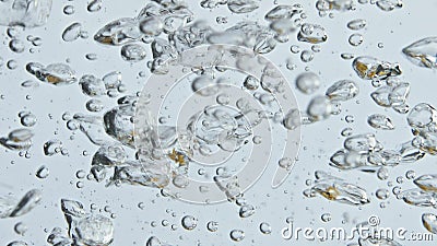 Air bubbles rising water surface closeup. Bubbling mineral liquid in light Stock Photo