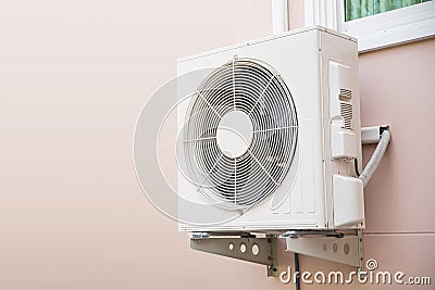 Air compressor, Close-up three external split wall type of outdoor home air conditioner unit installed on outside building. Stock Photo