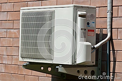 Air condition condenser unit hanging on wall Stock Photo