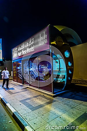 An air conditioned bus stop in Dubai with a tourist reflection in the glass Editorial Stock Photo