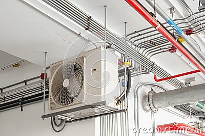 Air conditioner compressor installed and hanging on ceiling wall Stock Photo