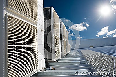 Air conditioner units with sun and blue sky Stock Photo