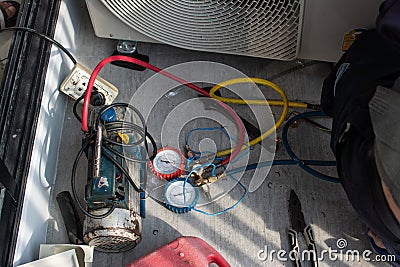 Air conditioning, HVAC service technician using gauges to check refrigerant Editorial Stock Photo