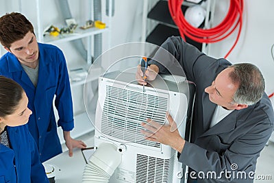 Air conditioning repairmen learning Stock Photo