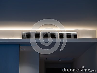 Air conditioning wall mounted ventilation system on ceiling in the white hotel room, front view. Stock Photo