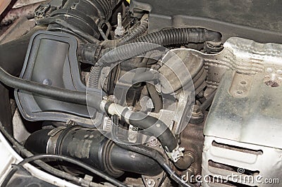 Air ducts and pipes under the hood of the car Stock Photo