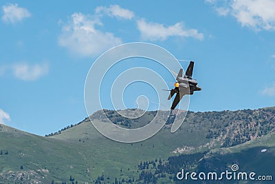 Air force F-35 from a demonstration team performs aerobatics at Hill AFB against Wasatch Mountains Editorial Stock Photo