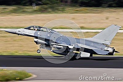 Air force fighter jet plane taking off from an airbase with full speed Stock Photo