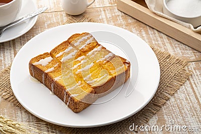 Air fryer grilled butter toast,golden brown crispy bread topped with sugar and sweetened condensed milk Stock Photo