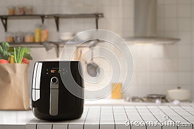 Air fryer machine cooking potato fried in kitchen. Lifestyle of new normal cooking Stock Photo